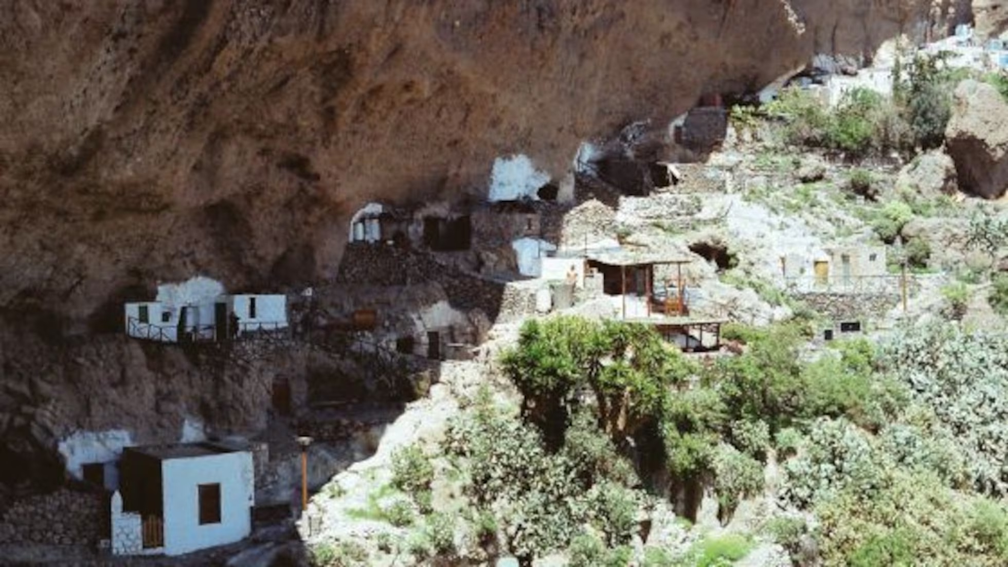 Historic cave settlement of Acusa Seca beneath the cliff