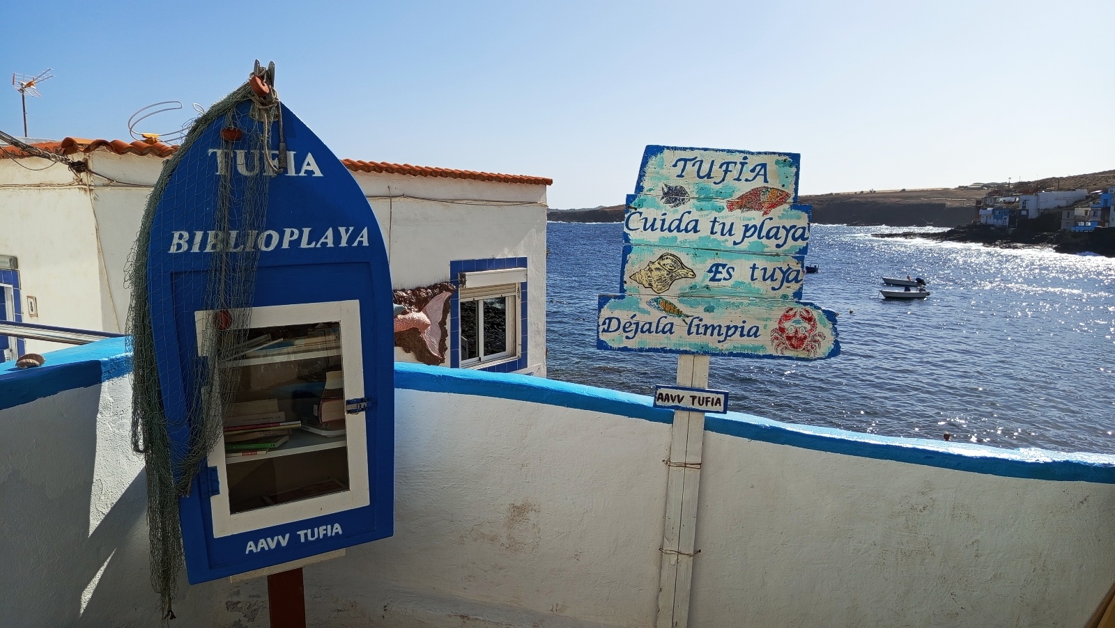 Tufia beach sign with sea view