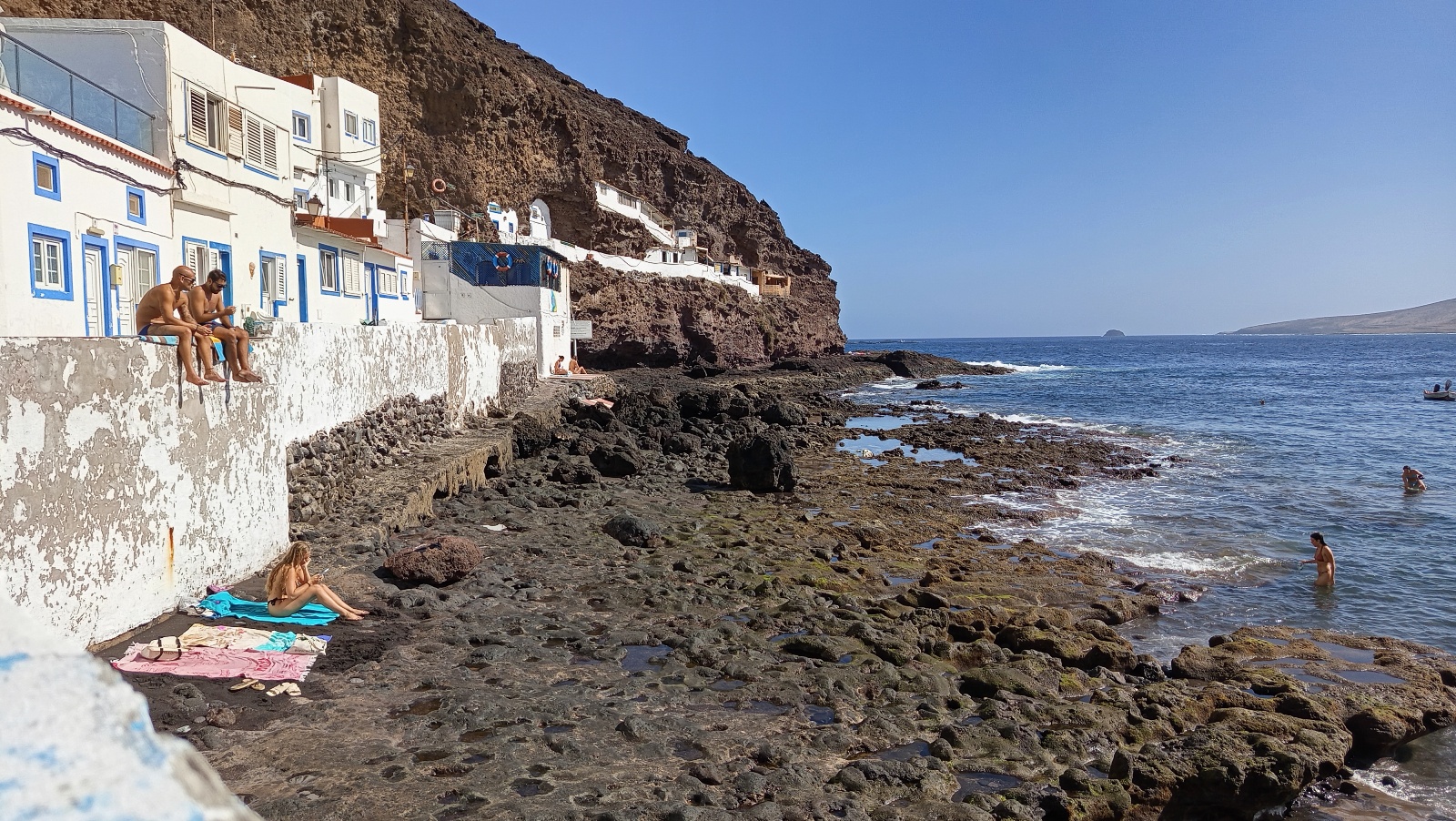 Tufia seafront with white houses and rocky shore